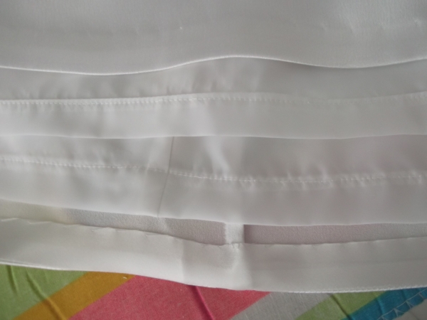 Bias-bound, hand stitched hem for the satin and machine stitched hem for the lining